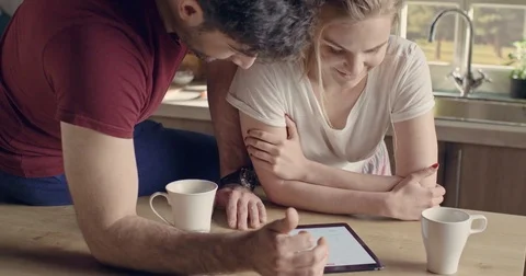 Beautiful happy couple using tablet Stock Footage 74513224