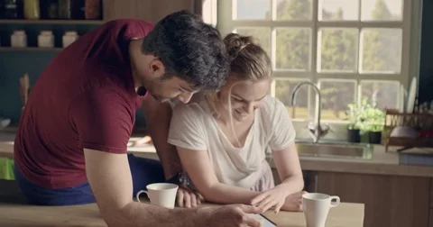 Beautiful happy couple using tablet and kissing Stock Footage 74513447