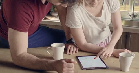 Beautiful happy couple using tablet and kissing Stock Footage 74513521