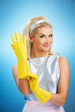 Beautiful happy housewife with rubber gloves Stock Photos