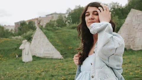 Beautiful happy young dark-haired woman enjoys the summer rain in the park. Stock Footage 199241633