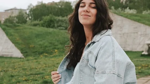 Beautiful happy young dark-haired woman enjoys the summer rain in the park. Stock Footage 199241635