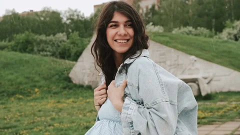 Beautiful happy young dark-haired woman enjoys the summer rain in the park. Stock Footage 199241688