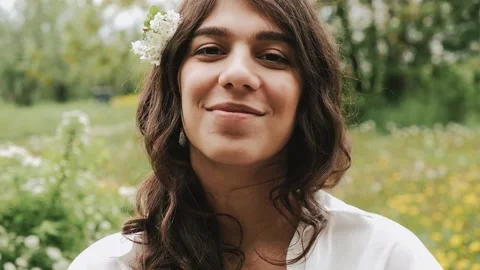 Beautiful happy young dark-haired woman enjoys the summer day in the park. Stock Footage 199241889
