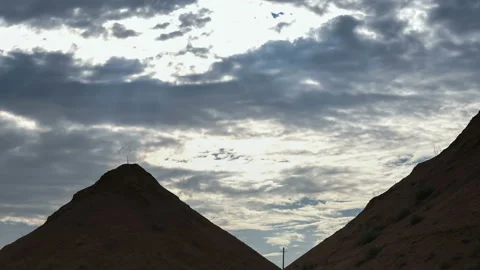 Beautiful heap clouds on the blue sky moving over sandy hills in the form of Stock Footage 93556980