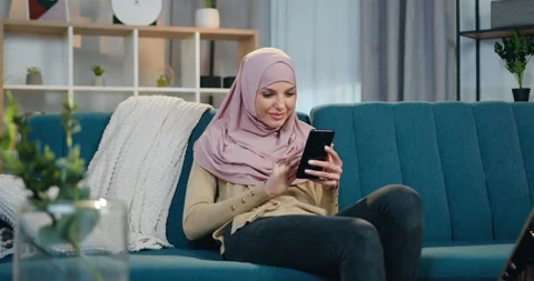 Beautiful in high spirits smiling young woman in hijab and casual clothes Stock Footage 150111116