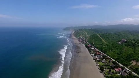 Beautiful high view from the ocean, waves, highway and a small village Stock Footage 145153699