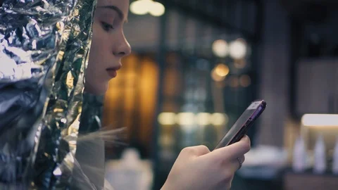 Beautiful hipster girl using app on smartphone in beauty salon while dyeing her Stock Footage 86697907