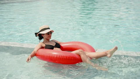 Beautiful Hispanic girl Sunbathing on rubber float floating by pool. happy Stock Footage 254548053