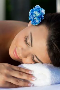 Beautiful hispanic woman relaxing at health spa Stock Photos