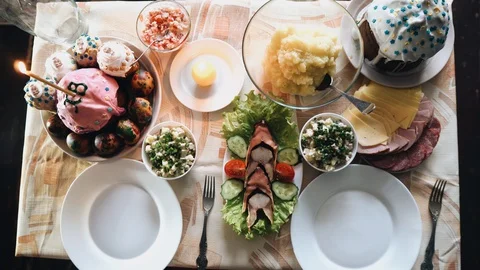 Beautiful holiday table with food. Easter cake and salads. Delicious food. Stock Footage 128715651