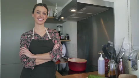 Beautiful home chef standing by kitchen stove Stock Footage 151002302