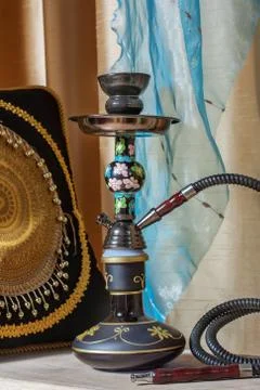 Beautiful hookah standing on a table in the eastern interior Stock Photos