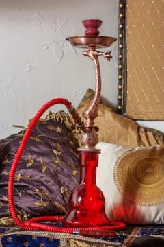 Beautiful hookah standing on a table in the eastern interior Stock Photos