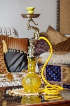 Beautiful hookah standing on a table in the eastern interior Stock Photos