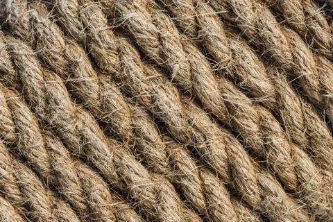 A beautiful horizontal pattern texture from yellow natural flax rope on dark Stock Photos