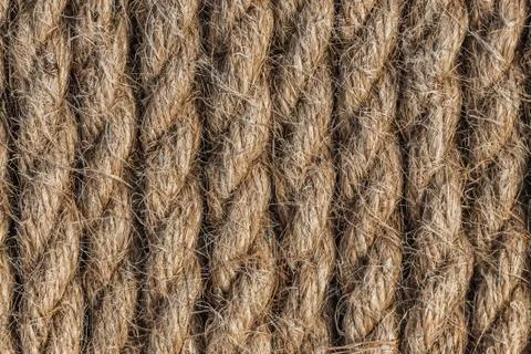 A beautiful horizontal pattern texture from yellow natural flax rope on dark Stock Photos