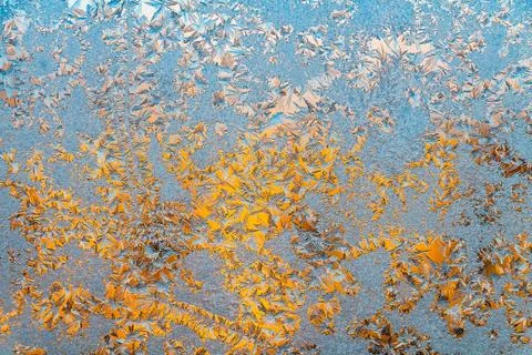 A beautiful horizontal texture in blue white and yellow color of frozen windo Stock Photos