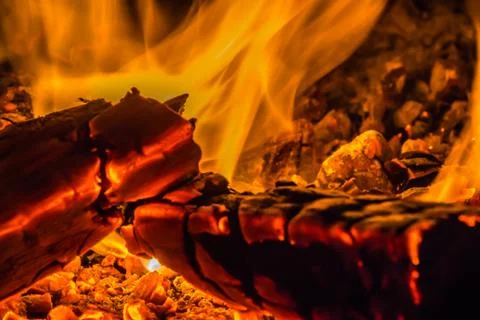 A beautiful horizontal texture of a burning fire on a black background with Stock Photos