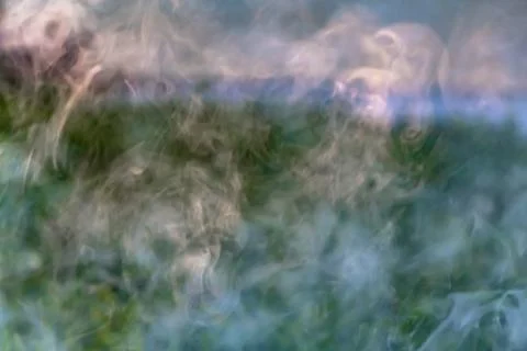 A beautiful horizontal texture of colored blur smoke in blue green purple whi 스톡 사진