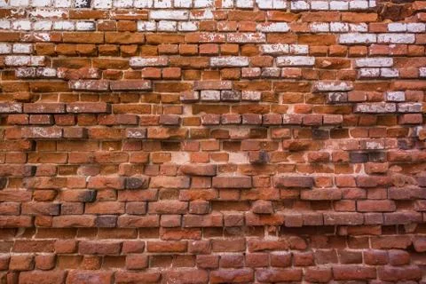 A beautiful horizontal texture of part of a old crashed brick wall in brown h Foto stock