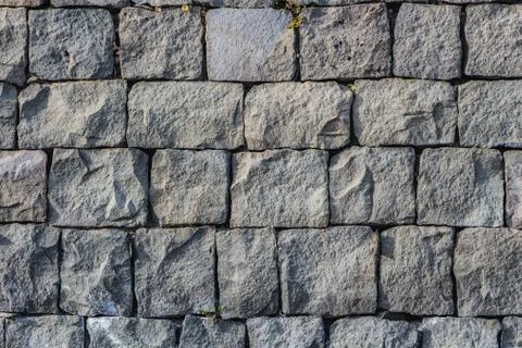 A beautiful horizontal texture of part of an old gray brick wall from frozen 스톡 사진