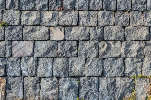 A beautiful horizontal texture of part of an old gray brick wall from frozen Foto stock