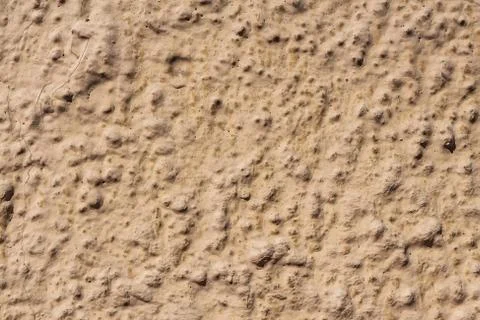 A beautiful horizontal texture of part of an old wall with yellow and orange Stock Photos