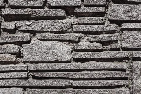 Beautiful horizontal texture of part of a old gray stone wall is on the photo Stock Photos