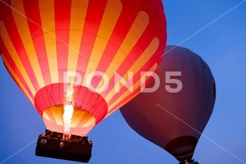Beautiful hot air balloons flying over Cappadocia landscape at sunrise Stock Photos