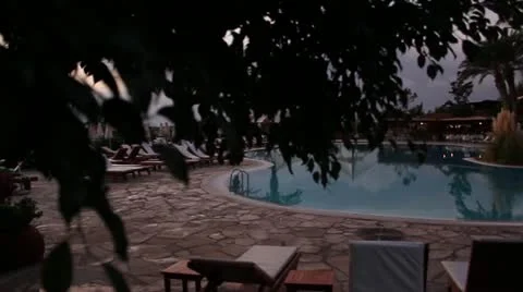 Beautiful hotel pool at sunset Stock Footage 20588932