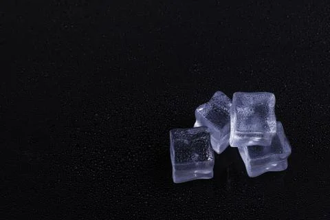 Beautiful ice cube on a black background. Stock Photos