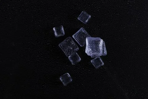 Beautiful ice cube on a black background. Stock Photos
