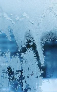 Beautiful ice pattern close-up on winter window glass Stock Photos