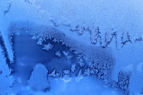 Beautiful ice pattern close-up on winter window glass Stock Photos