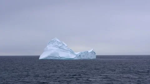 Beautiful Iceberg Floating in Calm Blue Antarctica Waters. Cloudy Sky Stock Footage 277920125