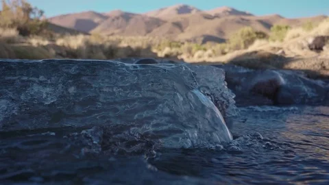 Beautiful icy stream cascades down desolate mountains in Bolivia Stock Footage 81886637