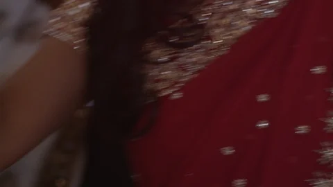 Beautiful Indian dancer dancing at a party with a red traditional dress and 動画素材 110770997