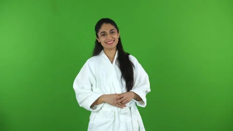 Beautiful Indian model laughing in a bathrobe against the green screen - adve... Stock Footage 275809604