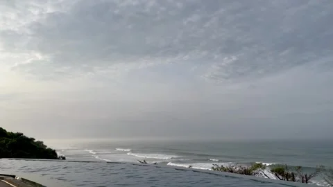 Beautiful Infinity Pool View Overlooking the Calm Ocean Waves Stock Footage 340256559