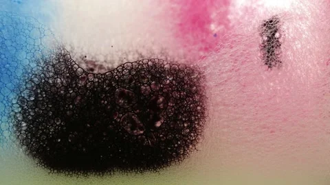Beautiful ink drops dissolving in the water. Colorful soap foam with popping Stock Footage 154423799