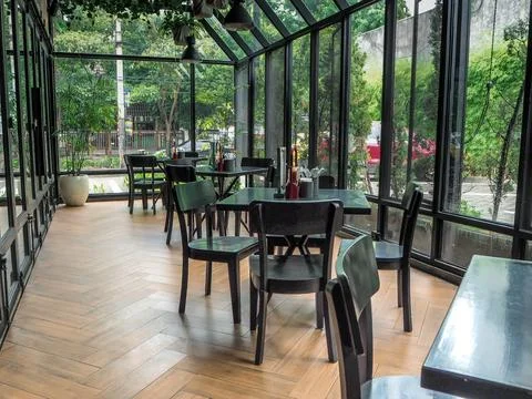Beautiful interior view of the Cafe, clear glass walls allow natural light .. Stock Photos