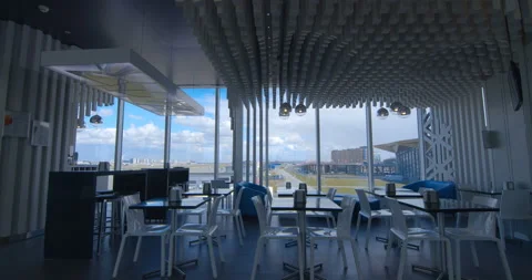Beautiful interiors inside the building where cafe overlooking the runway Stock Footage 119593761