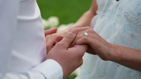 A Beautiful Intimate Wedding Ring Exchange Moment During a Romantic Outdoor Stock Footage 314574515