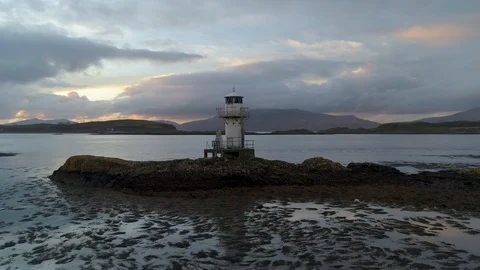 Beautiful isolated lighthouse surrounded by mountains Stock Footage 102412437
