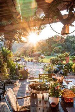 Beautiful italian terrace with view on a magical garden during sunset Stock Photos