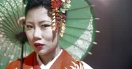 Beautiful Japanese Geisha Posing For The Camera With An Umbrella On Stage, Epic Stock Footage