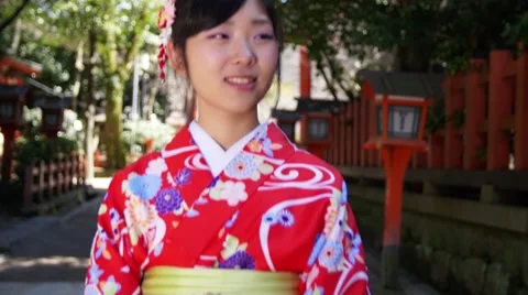 Beautiful Japanese girl wearing kimono explores Kyoto Streets slow motion Stock Footage