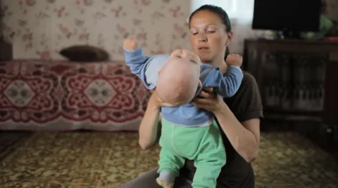 Beautiful kid does not listen to my mother at home. He was less than a year, and Stock Footage 64553803