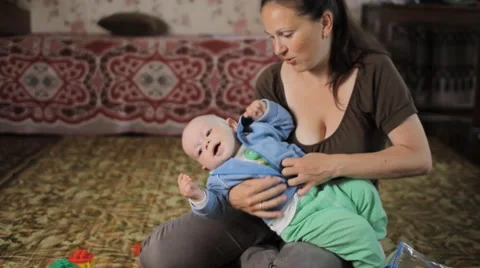 Beautiful kid does not listen to my mother at home. He was less than a year, and Stock Footage 64553893